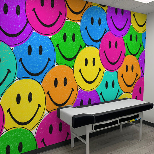 Colorful smiley face wall mural in a medical room.